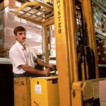 person operating yellow forklift