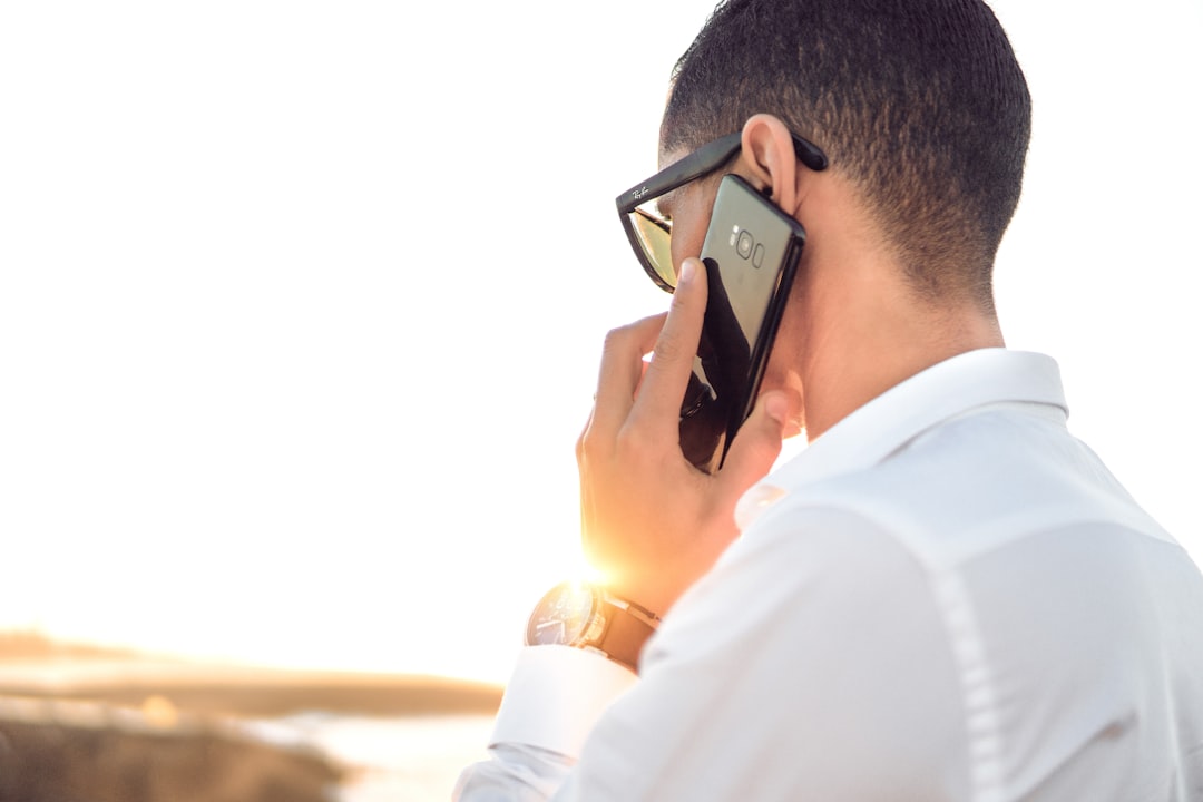 person wearing white shirt  talking on phone